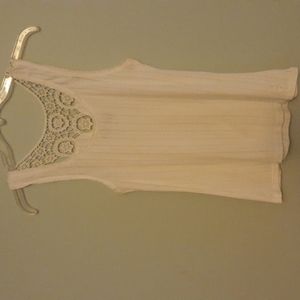 White cotton sleeveless top with decorative back.